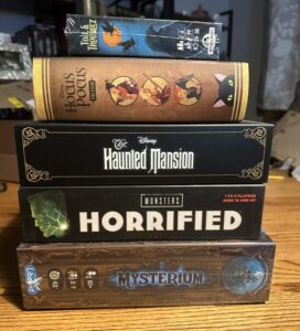 A stack of board games titled